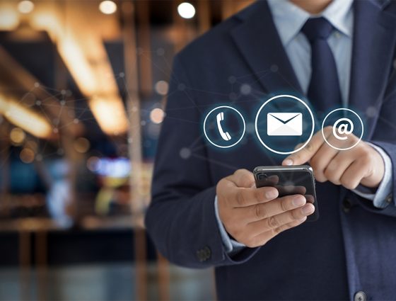 contact-us-hand-businessman-holding-mobile-smartphone-with-mail-phone-email-icon